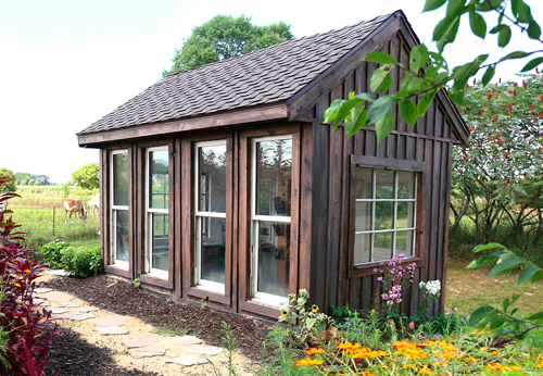 Wooden garden shed with windows.